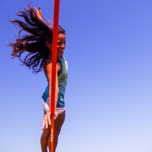 YogaSlackers Teacher Raquel Hernández-Cruz in side plank on a slackline