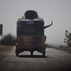 Waving out of a rickshaw